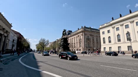 Vista-De-La-Estatua-Ecuestre-De-Federico-El-Grande-En-Berlín-Con-Tráfico-Ligero-Y-Ciclistas-Pasando-En-Un-Día-Soleado-En-Berlín