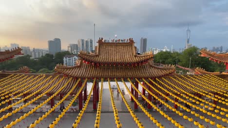 View-of-the-beautiful-yellow-lanterns-celebrating-Mazu's-Birthday-and-overlooking-the-cityscape-skyline-in-Thean-Hou-Temple,-Kuala-Lumpur,-Malaysia