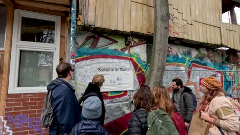 Tour-Guide-Explaining-History-Behind-Baumhaus-An-Der-Mauer-Tree-House-In-Berlin