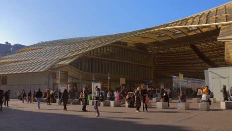 Astounding-exterior-shot-of-canopy-of-the-Chatelet-des-Halles-with-tourists-walking-around-in-Paris,-France-on-a-sunny-day