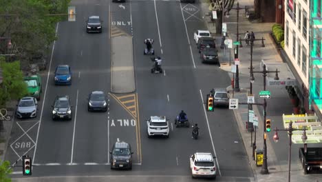Aerial-zoom-shot-of-men-riding-four-wheeler-quads-and-dirt-bikes-on-city-street-of-Philly