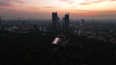Aerial-view-away-from-the-Chapultepec-castle-with-Reforma-skyline-background,-evening-in-Mexico-city