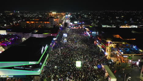 Aerial-view-over-the-illuminated-Feria-San-Marcos-fair,-night-in-Aguascalientes,-Mexico