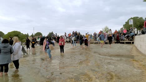 Crowds-of-visitors-to-Pamukkale-walk-barefoot-at-natural-hot-springs-attraction