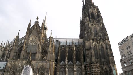 Looking-Up-At-Cologne-Cathedral-With-Slow-Pan-Left-Across-Shot-To-Station-Entrance