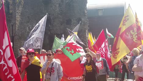 Slow-motion-of-Welsh-Independence-supporters-marching-with-their-large-flags