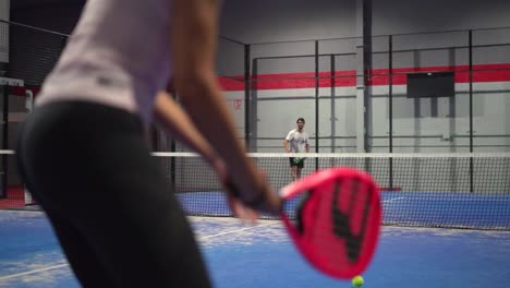 Murcia,-Spain,-May-23,-2023:-Young-sportswoman-and-man-couple-playing-padel-tennis-in-slow-motion