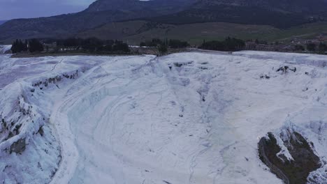 Drone-pull-shot-of-travertine-terraces-geothermal-attraction-Pamukkale