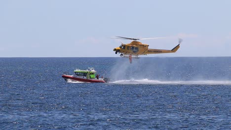 Rescue-Helicopter-Lowering-Crew-Member-Onto-Marine-Rescue-Boat-during-Training-Exercises,-Busselton-Western-Australia