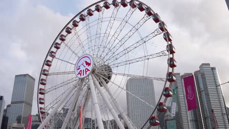 Hong-Kong-Observation-Wheel,-the-iconic-Central-Harbourfront-in-Hong-Kong,-with-AIA-company-logo