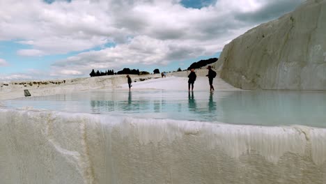 Visitors-to-Pamukkale-enjoy-beautiful-thermal-turquoise-water-pools-and-make-photos