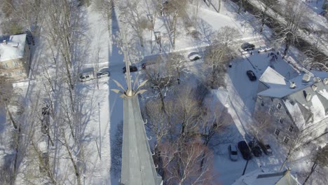 Drone-shot-of-Tartu-Katoliku-Kiriku-main-tower-with-cross,-on-background-we-can-see-Tähtvere-district