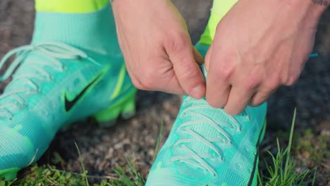 Macro-close-up-of-soccer-player-tying-sneakers-shoelaces