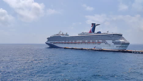 Luxury-Carnival-cruise-ship-reached-on-port-and-approaching-pier-slowly-to-dock-and-disembarking-guests-for-a-new-adventure-on-port-in-Mexico-|-Vacation,-Lifestyle,-enjoy,-Travel,-destination-Concept