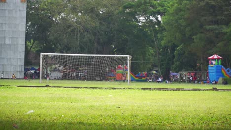 Kids-running-on-football-field.-City-park