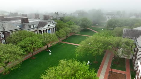 Aerial-rotation-over-academic-lawn-on-foggy-college-campus