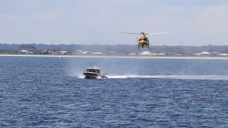 Low-Flying-RAC-Rescue-Helicopter-And-Marine-Rescue-Boat-Moving-Towards-Camera,-Geographe-Bay,-Busselton