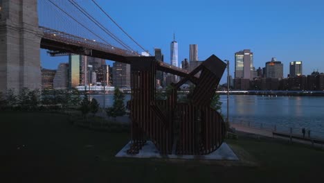 An-aerial-view-of-the-"LAND"-sculpture-in-Brooklyn-Bridge-Park-and-the-NYC-skyline-in-the-morning