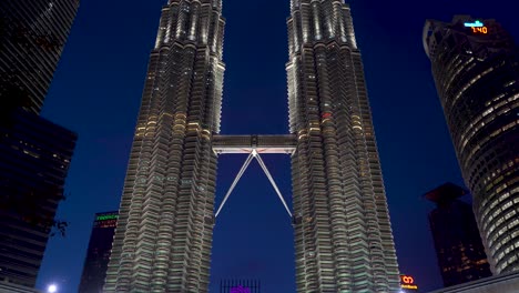 Slow-tilt-down-reveal-over-Petronas-Twin-Towers-at-night-with-famous-water-show
