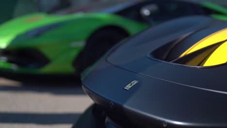 Focus-pull-from-Lamborghini-sign-to-Ferrari-sign