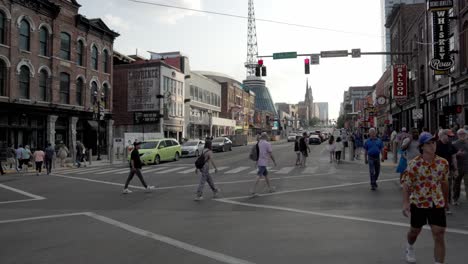 Broadway-Street-in-downtown-Nashville,-Tennessee-with-gimbal-video-panning-left-to-right-at-intersection