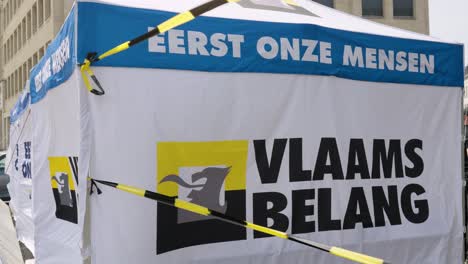 Logo-sign-of-far-right-party-Vlaams-Belang-on-tent-covered-with-ribbon-tape---Brussels,-Belgium