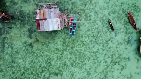 Look-down-aerial-shot-of-water-houses-and-boats