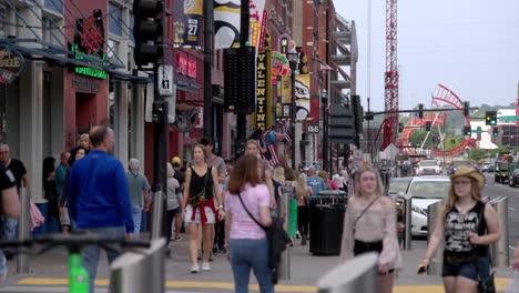 Broadway-Street-in-downtown-Nashville,-Tennessee-with-gimbal-video-panning-zoomed-in-close-up