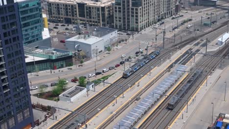 Aerial-tracking-shot-of-Amtrak-train-arriving-at-Union-Station-in-Denver,-Colorado