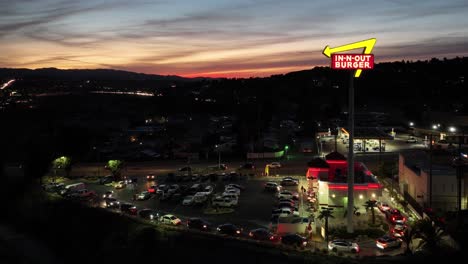 In-n-Out-Burger-fast-food-restaurant-is-very-busy-with-long-lines-during-sunset-at-the-sand-canyon-location-off-the-14-freeway-in-Santa-Clarita,-California