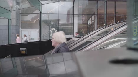 Woman-travelling-down-escalators-at-Buchanan-Street-Train-station