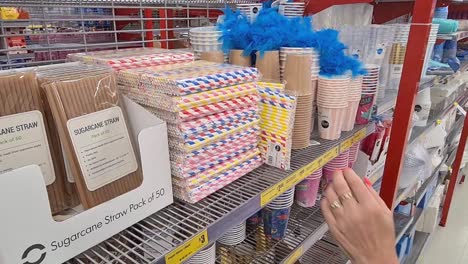 Corowa,-New-South-Wales,-Australia---3-February-2021:-Woman-looking-at-sugar-cane-and-plastic-drinking-straws-in-a-cut-price-retail-shop-in-Corowa,-NSW