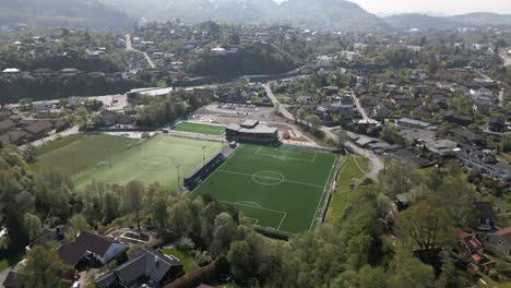 Forward-Tilting-Aerial-of-Football-Pitch-in-Nesttun,-Norway