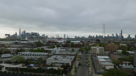 Red-Hook-industrial-area,-dark,-cloudy-day-in-Brooklyn,-NY---descending,-drone-shot