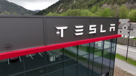 Logotipo-De-Tesla-En-La-Pared-Del-Moderno-Edificio-Del-Concesionario-De-Automóviles-Tesla-En-Forde-Noruega