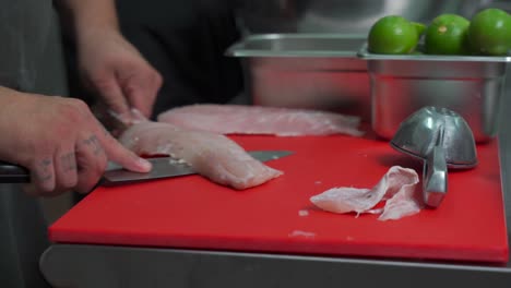 Mexican-latin-chef-cooker-filleting-preparing-cleanin-bass-fresh-fish-for-ceviche-recipe-at-mexico-kitchen