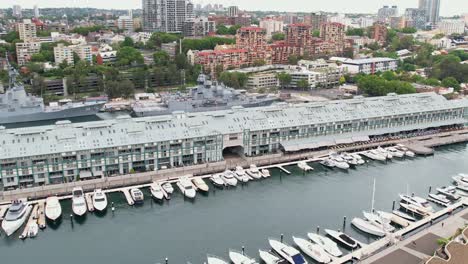 Sydney,-New-South-Wales-Australia---24-December-2021:-Boats-Moored-at-the-Marina-Beside-the-Finger-Wharf-in-Sydney-with-Garden-Island-Naval-Base-in-the-background