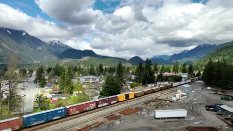 Freight-Trains-Moving-On-Railway-Through-Industrial-Area-In-Hope,-BC,-Canada