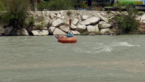 Adrenaline-adventure-tourists-river-rafting-in-rapid-flowing-river-gorge