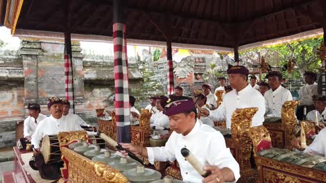 Local-Balinese-Orchestra-Plays-Gamelan-Music-with-Drums-and-Percussion-at-Day-Temple-Ceremony,-Ubud-Bali-Indonesia