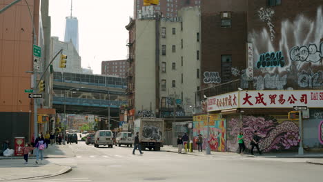 Chinatown-New-York-City-Street,-With-Train-Passing-On-Manhattan-Bridge