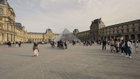 Tourists-Taking-Picture-And-Traveling-Around-The-Louvre-Pyramid-At-Grand-Louvre-Museum-In-Paris,-France
