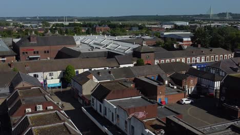 Aerial-view-above-market-street-town-retail-shops-and-supermarket-rooftops-during-economy-crisis