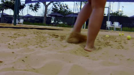 Feet-movement-on-the-sand-of-someone,-playing-beach-tennis