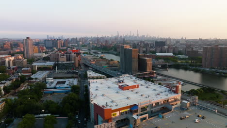Aerial-view-over-the-Bronx-Terminal-Market-11-toward-the-Manhattan-skyline,-sunset-in-New-York,-USA