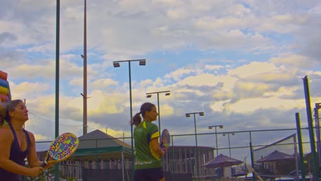 girls-enjoying-a-beach-tennis-training-in-a-sunset-of-a-cloudy-day-in-Brazil