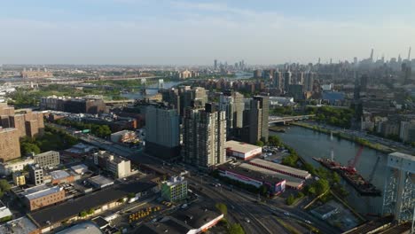 Aerial-view-approaching-riverside-condos-in-sunny-Mott-Haven,-Bronx,-New-York