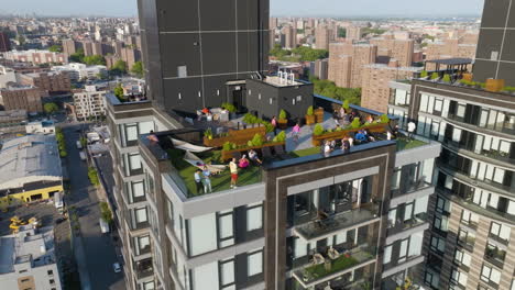 Aerial-view-around-people-enjoying-a-warm-day-in-a-terrace-apartment-of-New-York,-USA