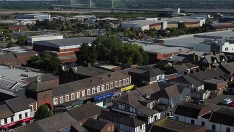 Aerial-view-pan-across-small-town-market-street-retail-shops-and-supermarket-rooftops-during-recession