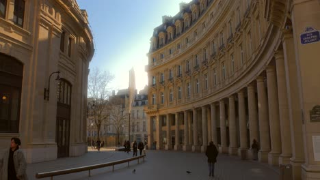 Shot-of-Bourse-du-commerce,-beautiful-building-alongside-a-walking-path-at-les-Halles-in-the-center-in-Paris,-France-on-a-sunny-day